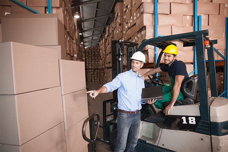How to become a forklift operator: Warehouse manager talking with forklift driver
