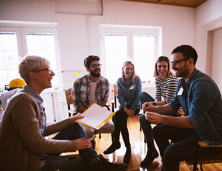 mental health at work: group of people laughing at work
