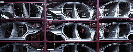 Automobile frames
                stacked in an assembly plant