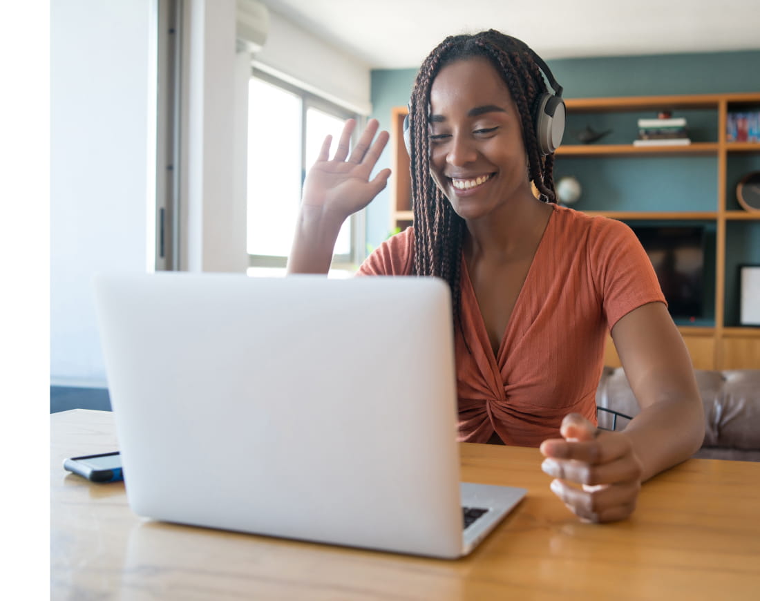 Woman working on laptop wearing headphones