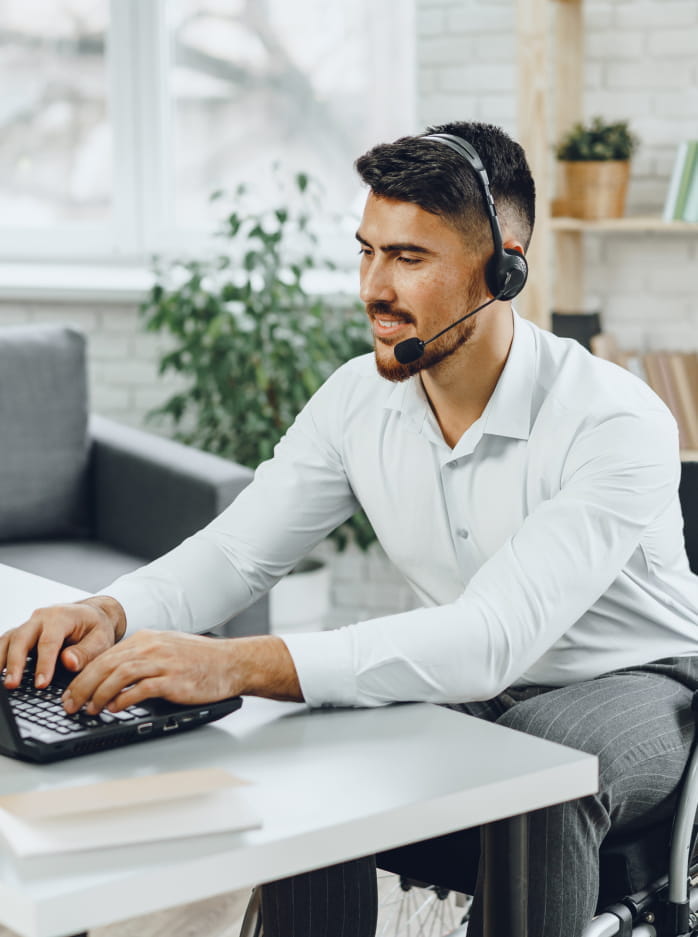 Man on a headset works at computer