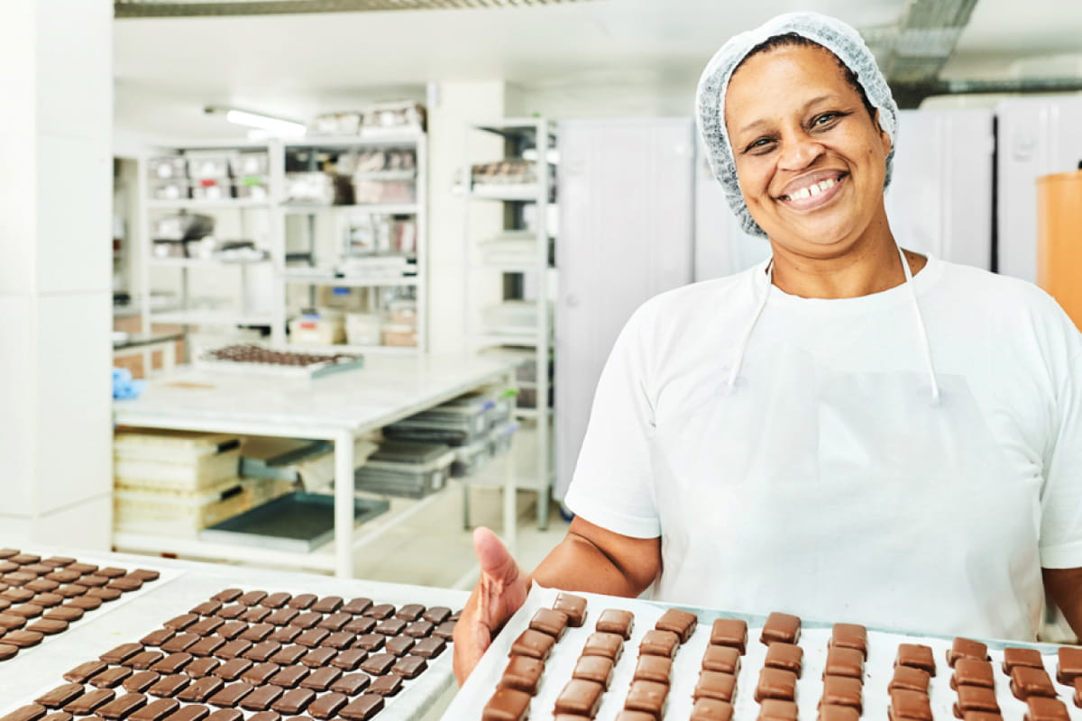 Employee showing a try of chocolates to the camera