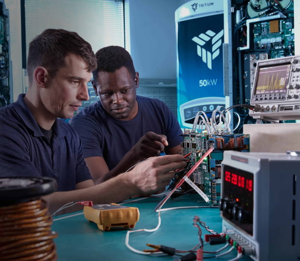 Two males working on internal electronics